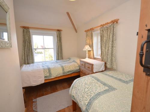 a bedroom with two beds and a window at 2 bed in Binham 26324 in Binham