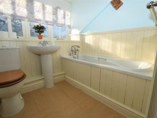 a bathroom with a toilet and a sink and a bath tub at 2 bed in Oswestry Powys 36577 in Pen-y-bont-fawr