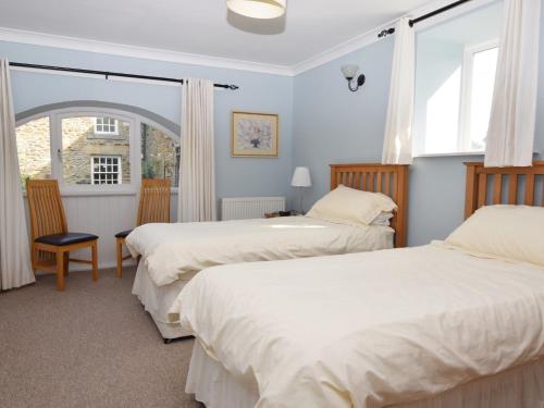 a bedroom with two beds and a window at 3 Bed in Wolsingham 36671 in Wolsingham