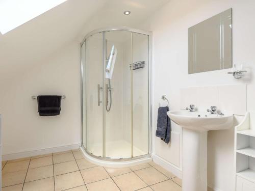 a bathroom with a glass shower and a sink at 3 bed in Brean WINDC in Berrow