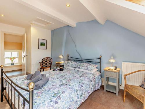 a bedroom with a bed and a chair at 3 Bed in Baslow PK908 in Baslow