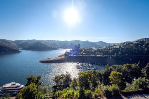 an island in a lake with a cruise ship at Blue Lake House in Ferreira do Zêzere