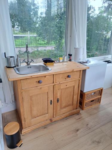 a kitchen counter with a sink and a window at Villa Benvenuto in Dieren