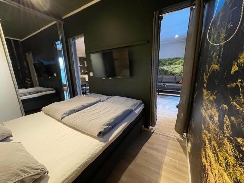 a bedroom with two beds and a large window at Apartment Lilletveitvegen in Bergen