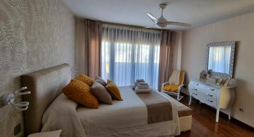 a bedroom with a bed and a dresser and a window at Casa Las 7 Maravillas in Fuentidueña de Tajo