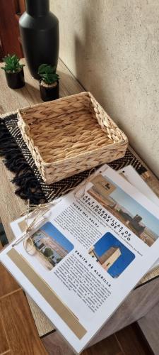 a table with a basket on top of a magazine at Casa Las 7 Maravillas in Fuentidueña de Tajo