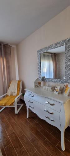 a bathroom with a white dresser and a mirror at Casa Las 7 Maravillas in Fuentidueña de Tajo