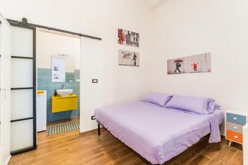 a bedroom with a bed and a mirror at CASA DI SILVIA a PORTA PIA in Rome