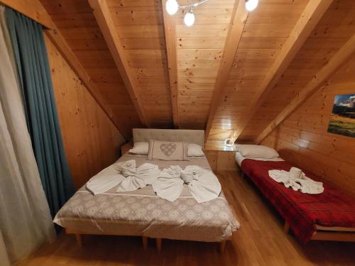 a bedroom with a bed in a wooden cabin at Al sentiero di Charly in Tarvisio