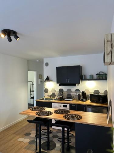 a kitchen with a stove and a counter top at L'échappée Cabourgeaise in Cabourg