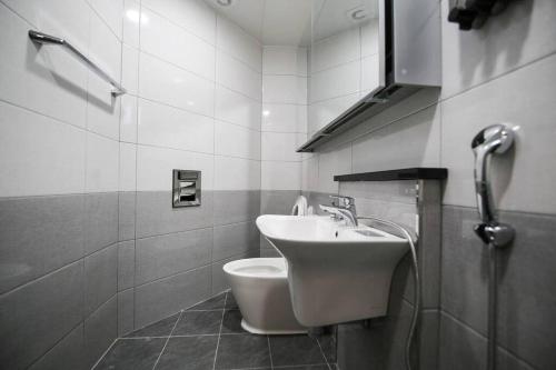 a bathroom with a sink and a toilet at Firenze guest house - 10mins to Incheon international Airport in Incheon