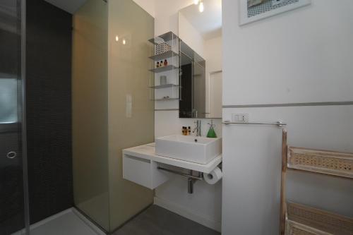 a bathroom with a sink and a mirror at Acquamarina 4 Pax by VILLASRETREATS in Portovenere