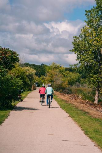 two people riding bikes down a dirt road at Weathervane Inn in Montague