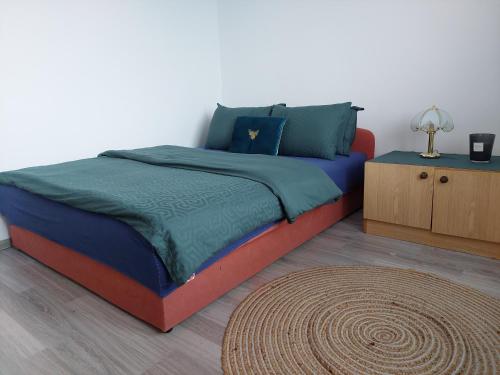 a bedroom with a bed with a blue and red at Apartmani Marin in Kupres