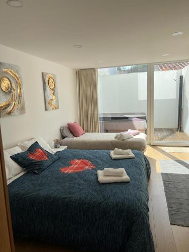 a bedroom with a bed with two towels on it at Moradia com jaccuzzi e sky view in Bombarral