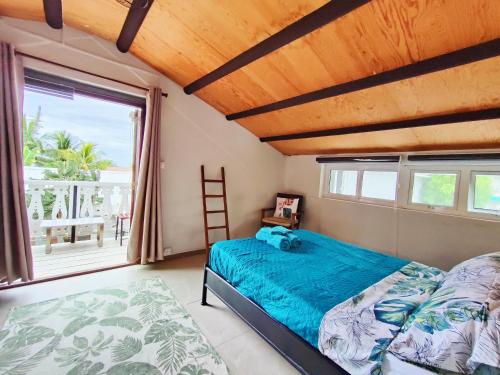 a bedroom with a bed and a large window at Mermaid Cove in Blue Bay