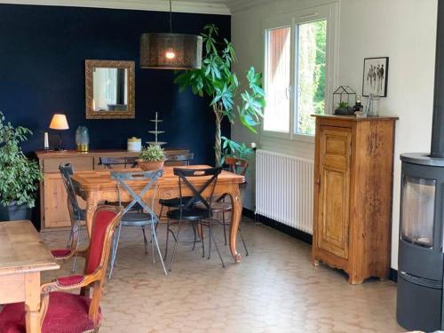 a dining room with a wooden table and chairs at Gite au coeur de la nature in Villers-Patras