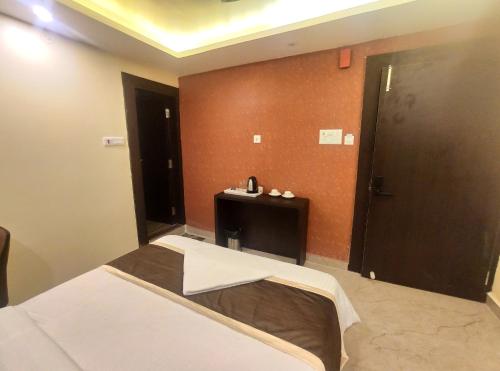 a hotel room with a bed and a door at Royal View Residency in Bodh Gaya