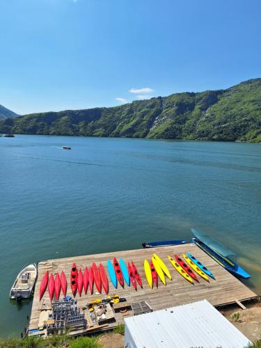 a dock with colorful umbrellas on a body of water at 5 Stinet in Koman