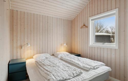 a bedroom with a bed and a window at Nice Home In Sby With 3 Bedrooms And Wifi in Sæby