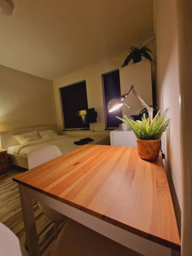 a room with a table and a bedroom with a bed at Cozy Private Room 2 on a Busy Persian Restaurant in Eindhoven
