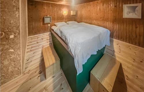 a bedroom with a bed in a wooden room at Gorgeous Home In Grsmark With Wifi in Gräsmark