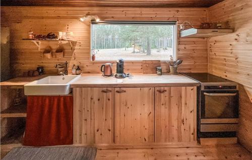 a kitchen with a sink and a window in a cabin at Gorgeous Home In Grsmark With Wifi in Gräsmark