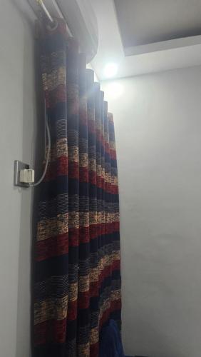 a curtain in a room with a door with a flashlight at Hotel Karachi in Karachi