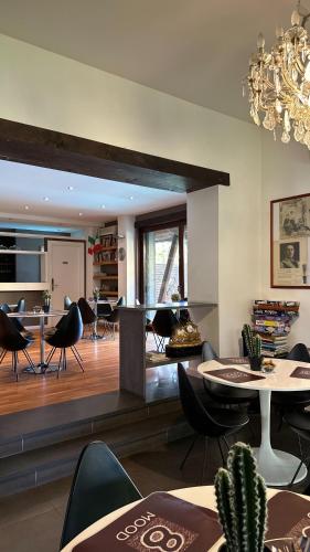 a living room with tables and chairs and a dining room at Ottomood B&B and Apartments in Tremestieri Etneo