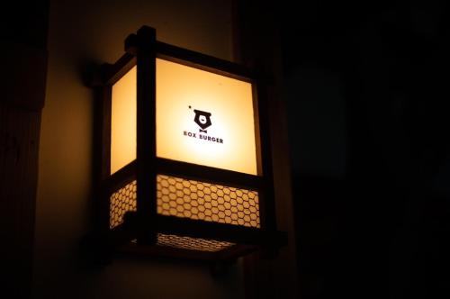 a light on a wall with the words new kitchen on it at Hakonowa in Hakone