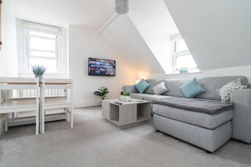 a living room with a couch and a table at Spacious 3-Bed, Town Centre, Parking, Near Beach in Bournemouth