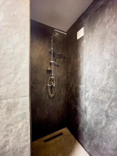 a bathroom with a shower with a glass door at HASS Boutique Hotel in Gostivar