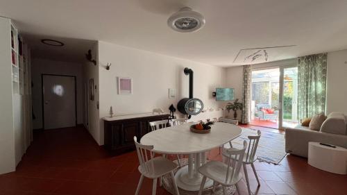 a kitchen and living room with a table and chairs at Garden Suite in Bolzano