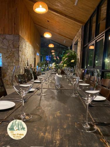 a long table with empty wine glasses on it at TVpalm Ecolodge in Ha Giang