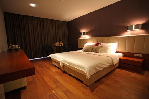 a bedroom with a large bed in a room at Hotel IN in Međugorje