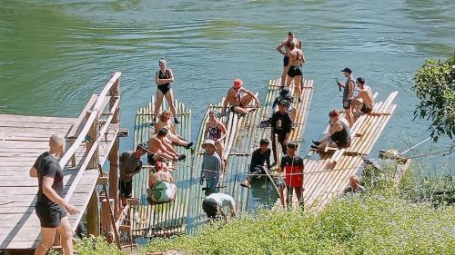 a group of people standing on a dock in the water at Banlung Mountain View Treks & Tours in Banlung