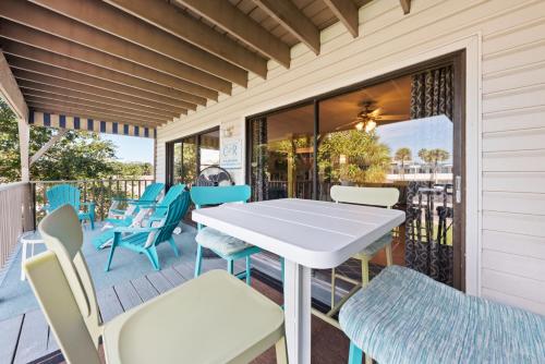 a porch with a white table and chairs at Beach Villa 2 Bedroom in Clearwater Beach