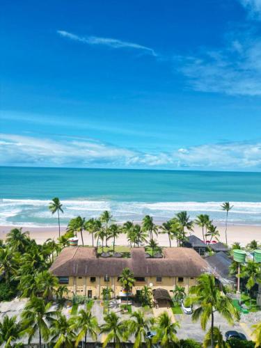 an aerial view of a resort with palm trees and the beach at Beira Mar Porto de Galinhas Hotel in Porto De Galinhas