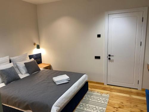 a bedroom with a bed with two towels on it at Arevaham Boutique Hotel in Stepʼanavan