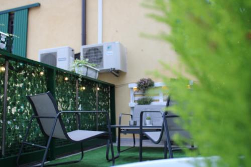a group of chairs and a table on a balcony at Baracca Apartment in Massa Lombarda