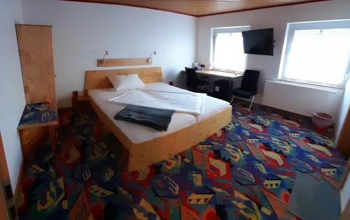 a bedroom with a bed with a colorful carpet at Smile Hotel in Nuremberg