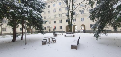 a park covered in snow in front of a building at Better Place Varso Center in Warsaw
