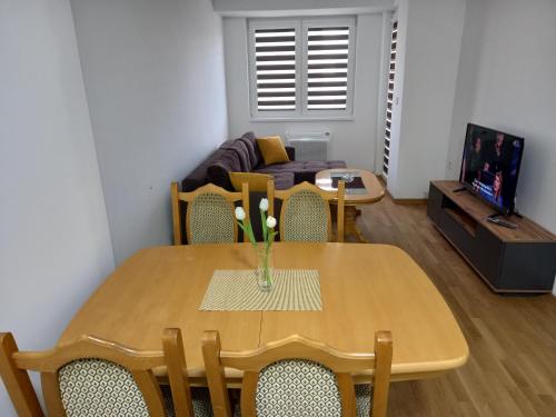a living room with a table and a couch at Apartman Mircevski in Skopje