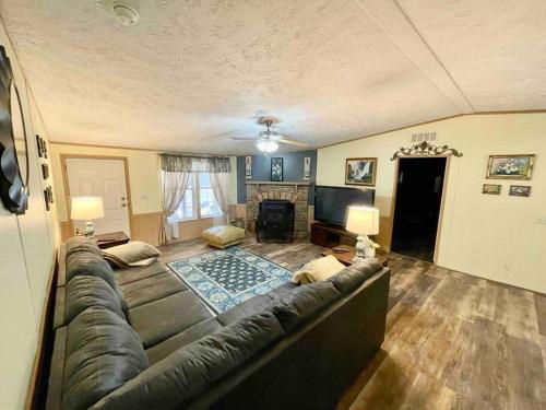 a living room with a couch and a fireplace at Country views and hikes. in Kyles Ford