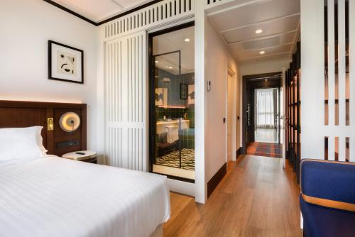 a bedroom with a white bed and a mirror at Hotel Tres Reyes San Sebastián in Donostia-San Sebastián