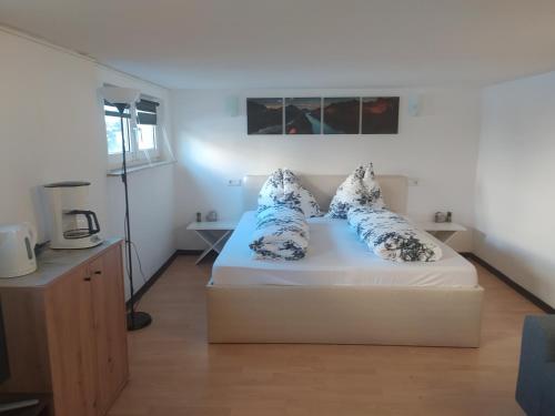 een slaapkamer met een bed met blauwe en witte kussens bij Ferienwohnung in Espenau