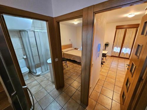 a view of a room with a bed and a bathroom at Hostal JP y Apartamentos in Sangüesa