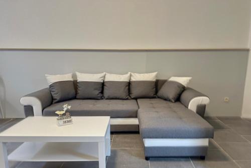 a living room with a couch and a table at Charbonnel 2 Bruxelles-Charleroi-airport in Charleroi