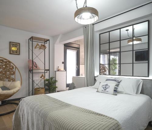 a bedroom with a bed and a large window at Atico Lujo Costa Vasca Bilbaoterraza mar jacuzi in Santurce