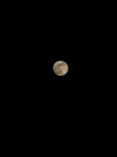 a full moon in the sky at night at شاليهات رمال بديه in Al Raka